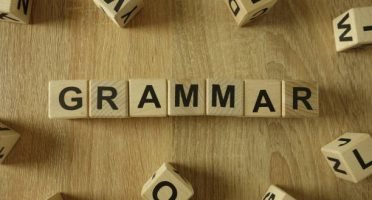 Grammar word from wooden blocks on desk